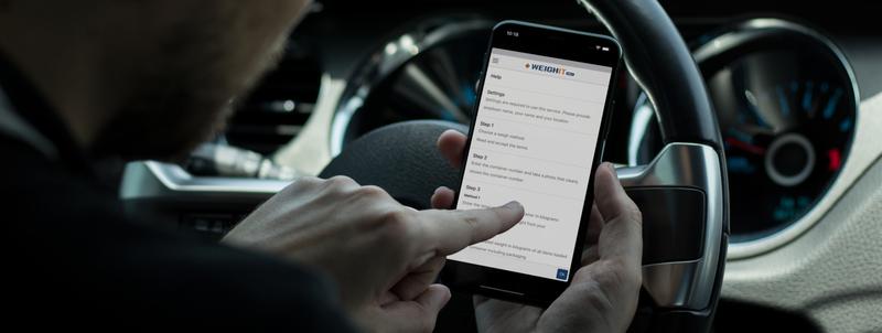 Man looking at iPhone in car